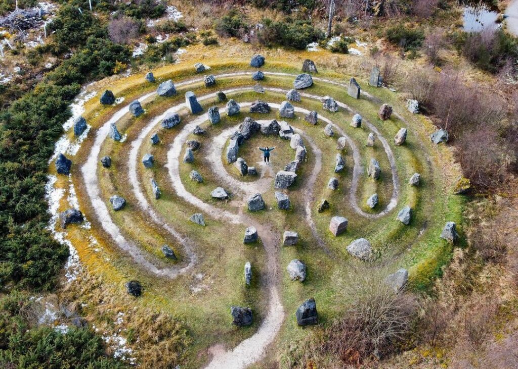 Aerial view of the Touchstone Maze near Strathpeffer, showing its circular stone labyrinth laid out on the hillside.