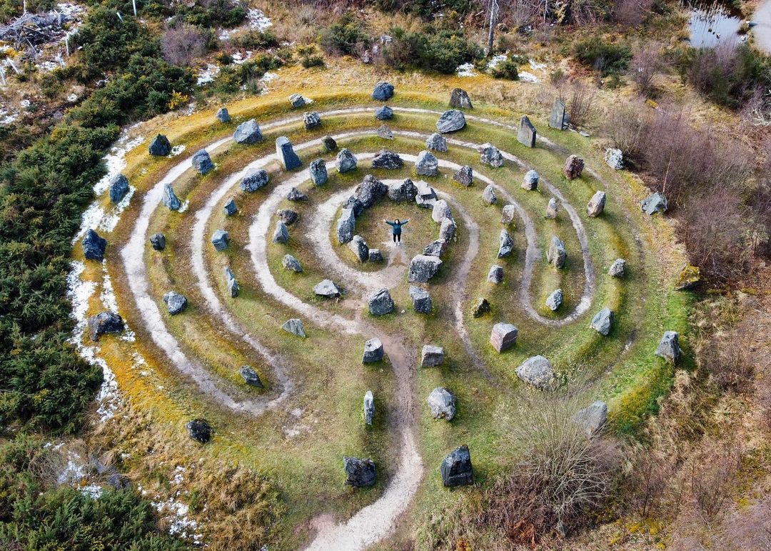 Aerial view of the Touchstone Maze near Strathpeffer, showing its circular stone labyrinth laid out on the hillside.