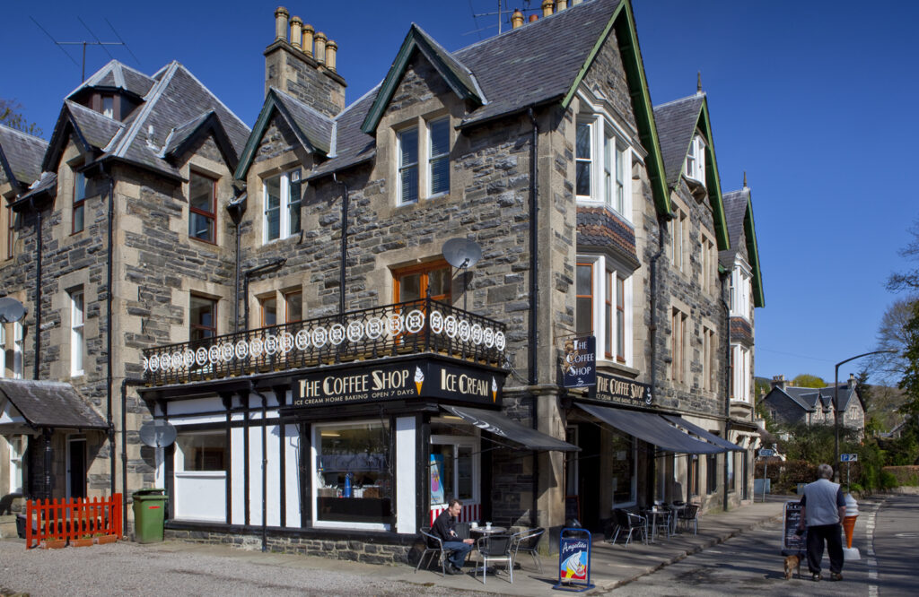 Cromartie Buildings in Strathpeffer, a historic stone building with The Coffee Shop on the ground floor.