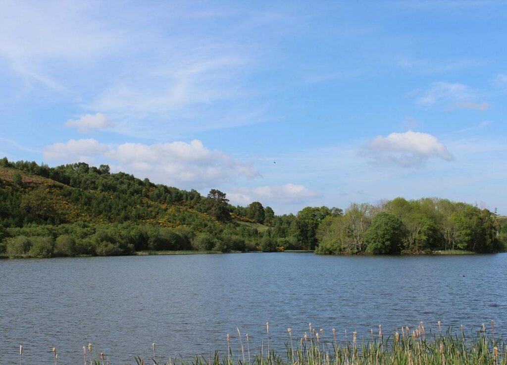 View across Loch Kinellan near Strathpeffer, with the crannog island at the centre of the loch.
